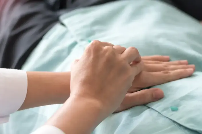 person putting hand on patient chest