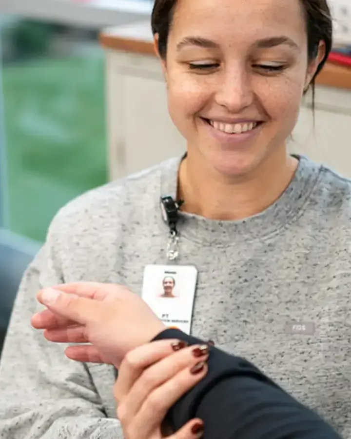 a woman is holding a card in her hand