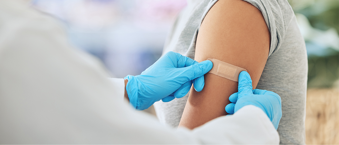 adult-getting-bandage-after-vaccine-in-clinic