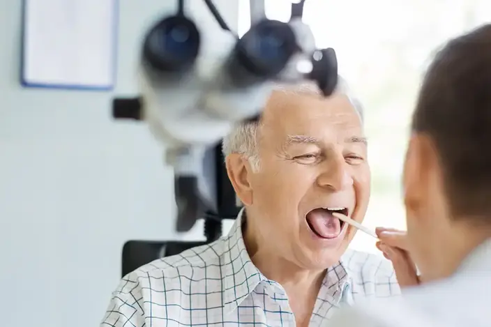 doctor checking patient's throat