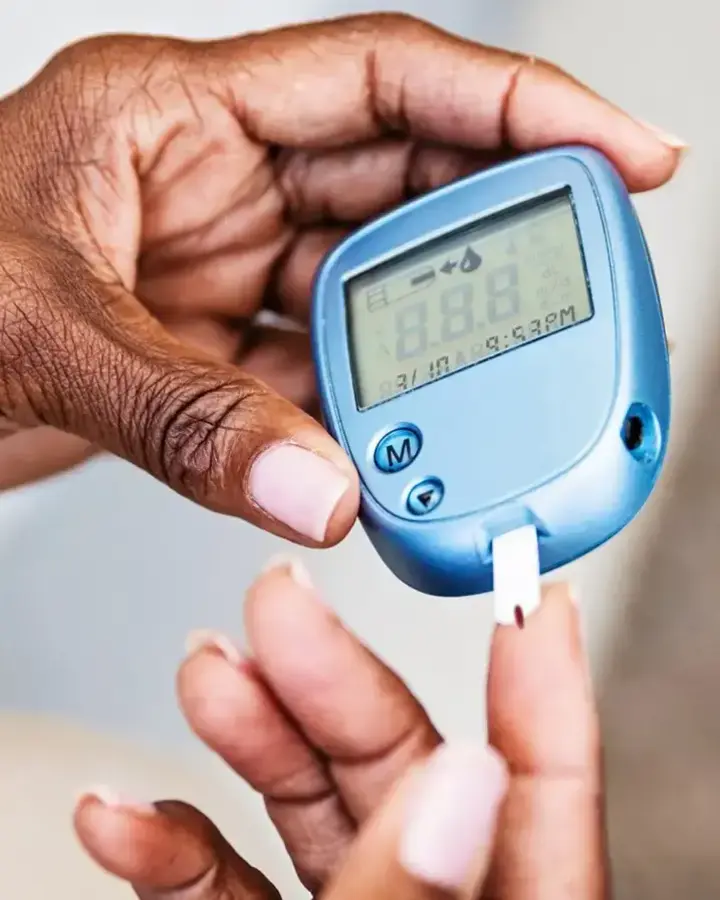person holding a glucose device