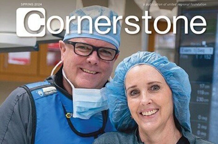 Two-cardiac-providers-standing-in-front-of-cardiac-equipment