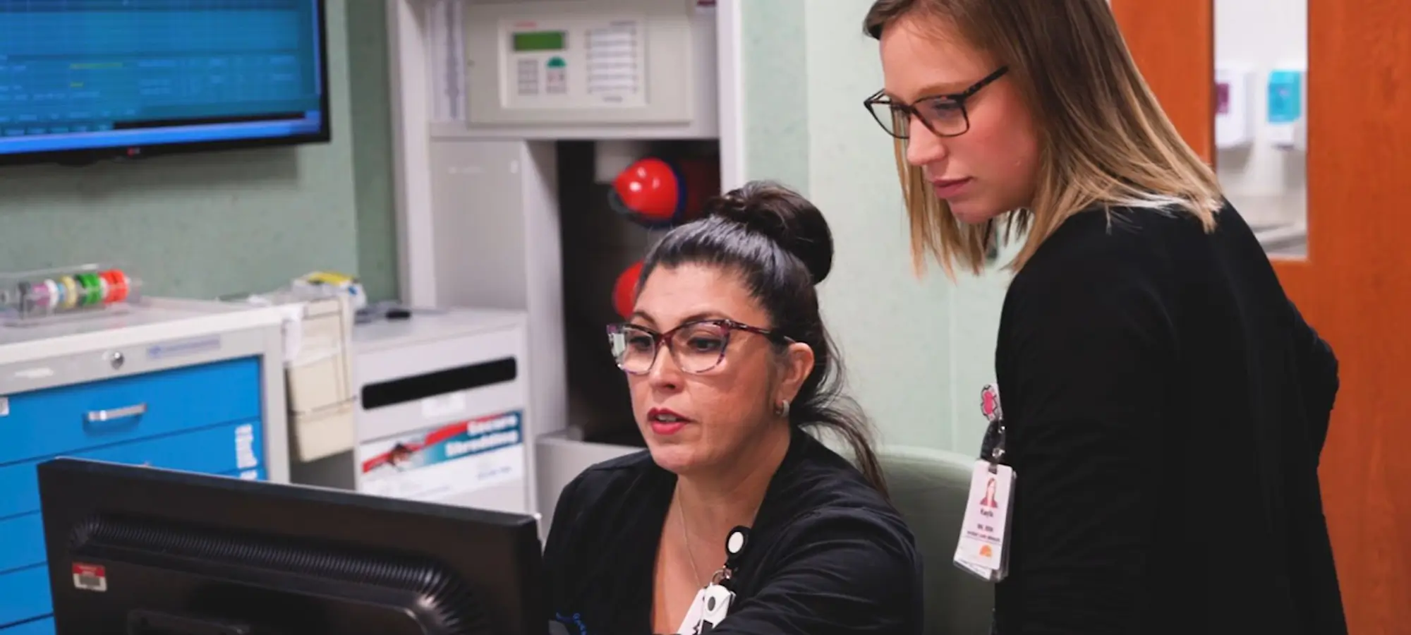 two women looking at computer screen
