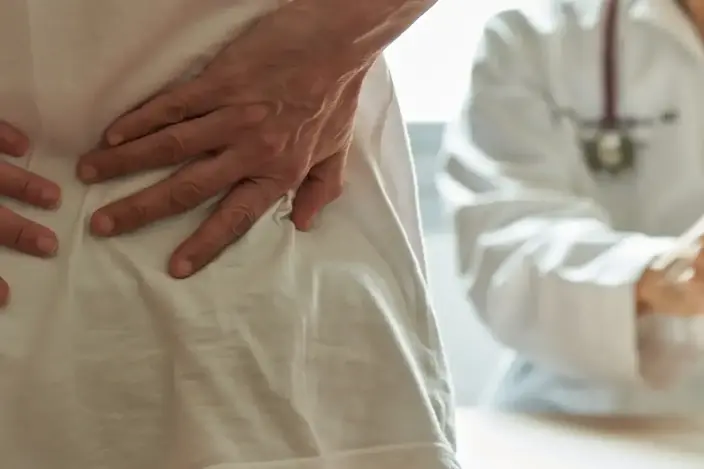 doctor with spine model and patient