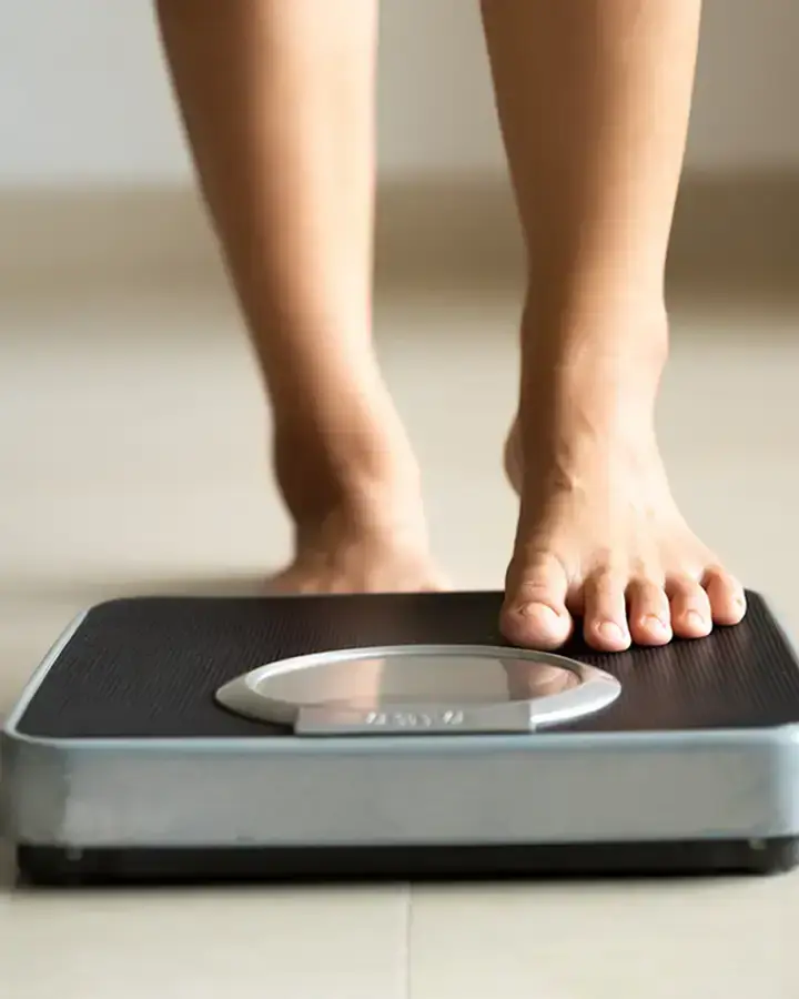 person stepping on to a scale